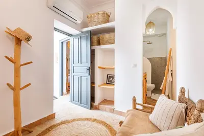 a living room with a blue door and a couch at Riad Belvi - Breakfast - 10mn Jemaa El Fnaa-Pool in Marrakech