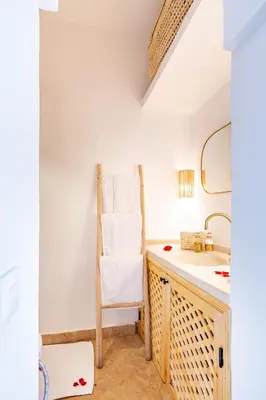 a bathroom with a chair and a sink at Riad Belvi - Breakfast - 10mn Jemaa El Fnaa-Pool in Marrakech