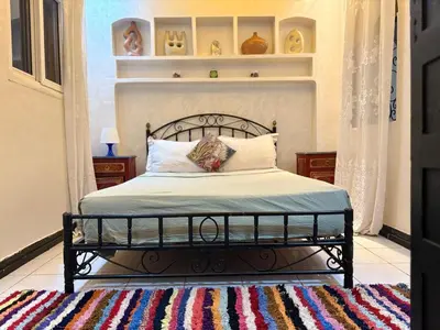 a bedroom with a black bed with a rug at M-S Riad in Marrakech