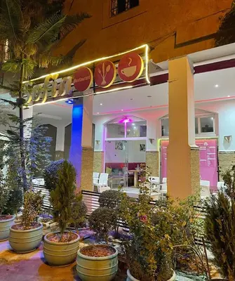 a restaurant with potted plants in front of a building at M-S Riad in Marrakech
