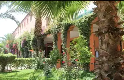 a building with a lot of plants and flowers at M-S Riad in Marrakech