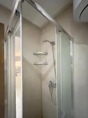 a shower with a glass door in a bathroom at Le Spacieux de Gueliz avec Piscine et Terasse in Marrakech