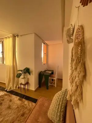 a living room with a couch and a desk at Refined apartment DOWNTOWN in Marrakech