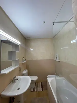 a bathroom with a sink and a tub and a toilet at Refined apartment DOWNTOWN in Marrakech