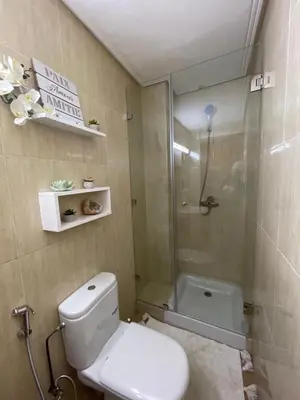a bathroom with a toilet and a shower at Refined apartment DOWNTOWN in Marrakech