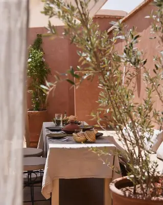 a table with plates of food and glasses on it at Riad Muarid in Marrakech