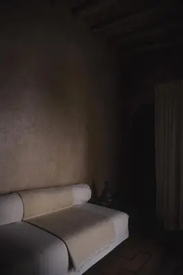 a corner of a room with a bed with a book at Riad Muarid in Marrakech