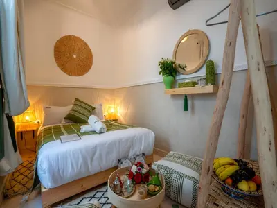 a bedroom with a bed in a room with a mirror at Yacouta Riad and Spa in Marrakech