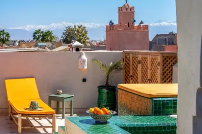 a bowl of oranges on a table on a balcony at Yacouta Riad and Spa in Marrakech