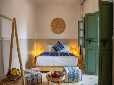 a bedroom with a bed with blue and white at Yacouta Riad and Spa in Marrakech