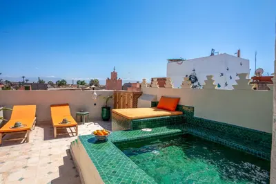 a swimming pool on the roof of a house at Yacouta Riad and Spa in Marrakech