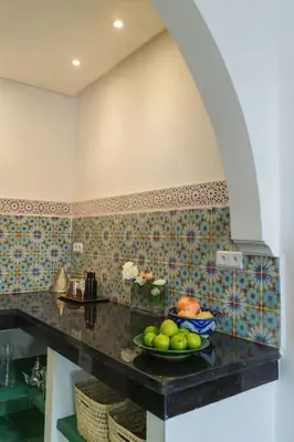 a kitchen with a bowl of fruit on a counter at Riad Pistache 135m2 in der Medina mit Terrasse in Marrakech