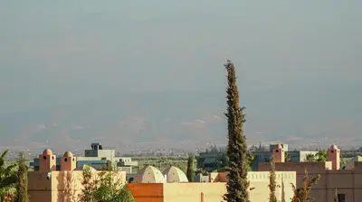a view of a city with a mountain in the background at VILLA Atlas in Sraghna