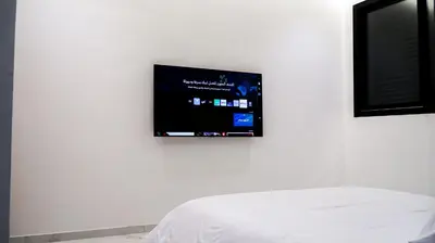 a flat screen tv hanging on a white wall at VILLA Atlas in Sraghna
