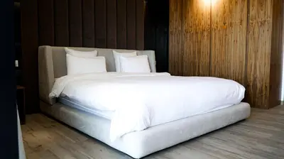 a large white bed with white sheets and pillows at VILLA Atlas in Sraghna