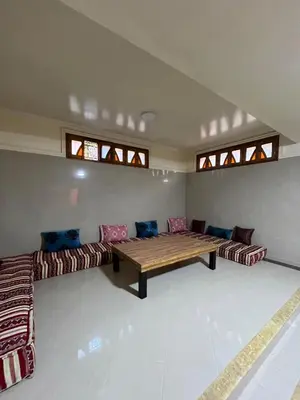 a living room with a wooden table and couches at Villa riad al salam in Marrakech