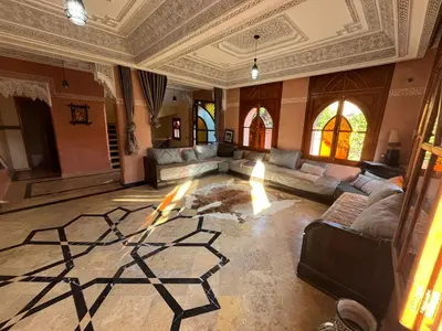 a large living room with couches and a fireplace at Villa riad al salam in Marrakech