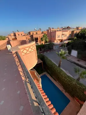 a view of a swimming pool from the roof of a building at Villa riad al salam in Marrakech
