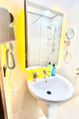 a bathroom with a white sink and a mirror at Appartement Sofia in Marrakech