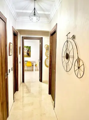 a hallway with a bike hanging on the wall at Appartement Sofia in Marrakech