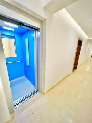 an empty hallway with a blue door in a room at Appartement Sofia in Marrakech