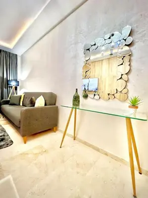 a living room with a couch and a glass table at Appartement Sofia in Marrakech