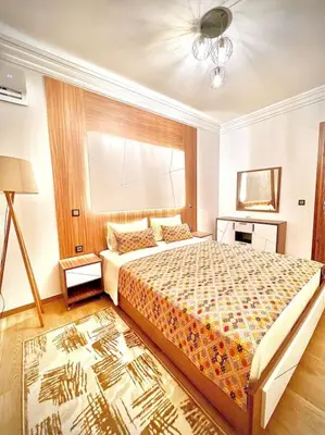 a bedroom with a large bed and a window at Appartement Sofia in Marrakech