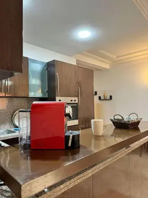a kitchen with a red appliance on a counter at Cosy Appartement Famille in Marrakech