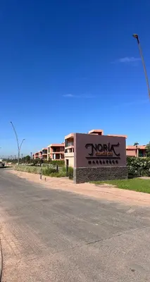 a sign for a hotel on the side of a road at Luxueux appartement Golf Noria in El Makina