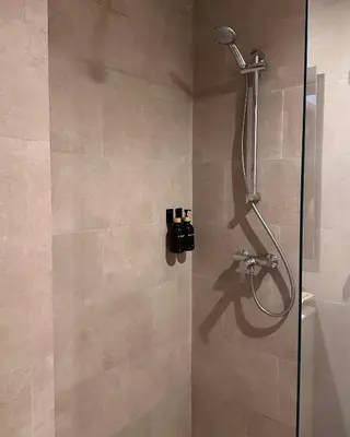 a shower in a bathroom with a glass door at Luxueux appartement Golf Noria in El Makina