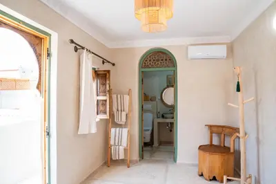 a hallway with a bathroom with a toilet and a mirror at Riad Eden Dorient in Marrakech