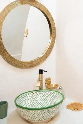 a bathroom with a green sink and a mirror at Riad Eden Dorient in Marrakech