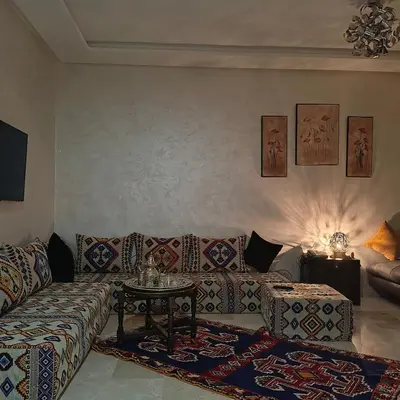 a living room with a couch and a table at Très belle expérience ! in Marrakech