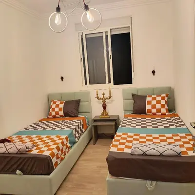 a room with two beds and a couch at Très belle expérience ! in Marrakech