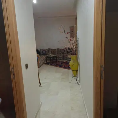 a hallway with a living room with a yellow vase at Très belle expérience ! in Marrakech