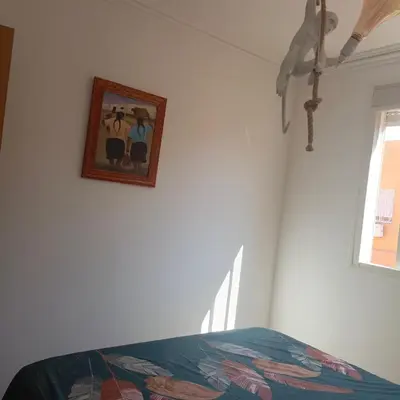 a bedroom with a picture on the wall and a bed at Très belle expérience ! in Marrakech