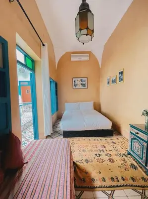 a bedroom with two beds and a window at Riad Bouhalla 240m2 in der Medina mit Terrasse in Marrakech