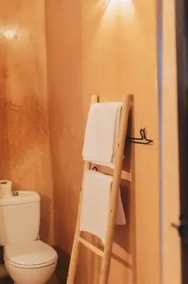 a bathroom with a toilet and a wooden ladder at Riad Bouhalla 240m2 in der Medina mit Terrasse in Marrakech