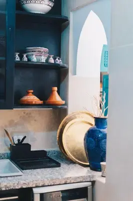 a kitchen with a counter with a blue vase on it at Riad Bouhalla 240m2 in der Medina mit Terrasse in Marrakech