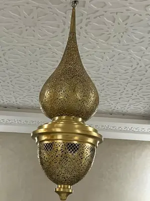 a gold chandelier hanging from a ceiling at Cozy Apartment Near Airport Terminal Modern Apartment Close to Airport in Marrakech