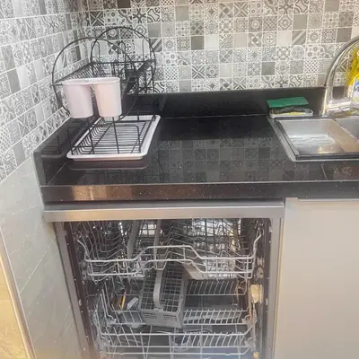 a dishwasher with dishes in it in a kitchen at Cozy Apartment Near Airport Terminal Modern Apartment Close to Airport in Marrakech