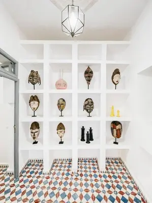 a room with a wall filled with lots of masks at Riad Dar Cidi 100m2 in der Medina mit Terrasse in Marrakech