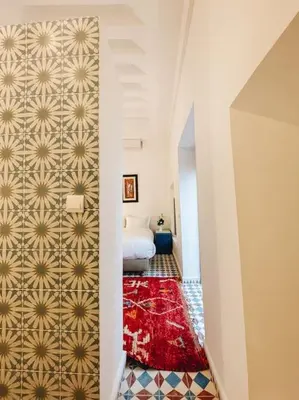 a hallway with a room with a bed and a red rug at Riad Dar Cidi 100m2 in der Medina mit Terrasse in Marrakech