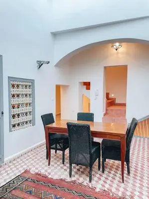 a dining room with a wooden table and chairs at Riad Dar Cidi 100m2 in der Medina mit Terrasse in Marrakech