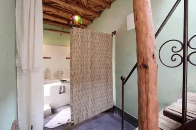 a bathroom with a bath tub and a bathroom with a sink at Riad Petit Palais 100m2 in der Medina mit Terrasse in Marrakech