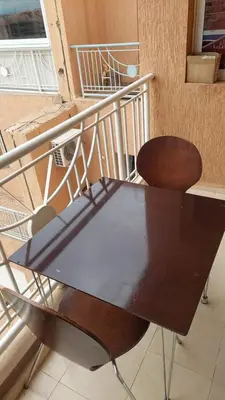 a table and a chair on a balcony at appartement 29 entier avec balcon in Marrakech