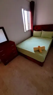 a small bedroom with a bed and a window at appartement 29 entier avec balcon in Marrakech