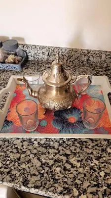 a tea kettle on a counter with glasses on it at appartement 29 entier avec balcon in Marrakech