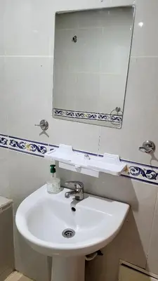 a bathroom with a white sink and a mirror at appartement 29 entier avec balcon in Marrakech