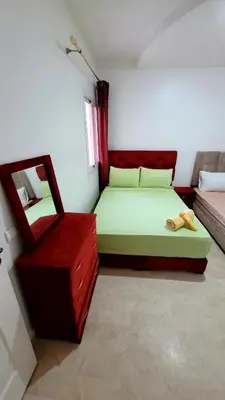 a bedroom with a bed and a mirror and a chair at appartement 29 entier avec balcon in Marrakech